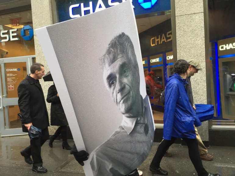 Mourners carry photo of priest and peace activist the Rev. Daniel Berrigan during funeral march to Church of St. Francis Xavier in New York City. Photo by RNS/Heidi Thompson