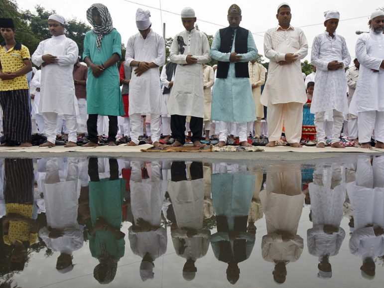 Muslims offer prayers as they are reflected in the stagnant rainwater on a road on the occasion of Eid al-Fitr in Kolkata, India, on July 18, 2015. The Eid al-Fitr festival marks the end of the holy month of Ramadan. Photo courtesy of REUTERS/Rupak De Chowdhury