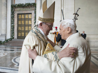 Pope Francis embraces Emeritus Pope Benedict XVI before opening the Holy Door to mark opening of the Catholic Holy Year, or Jubilee, in St. Peter's Basilica, at the Vatican