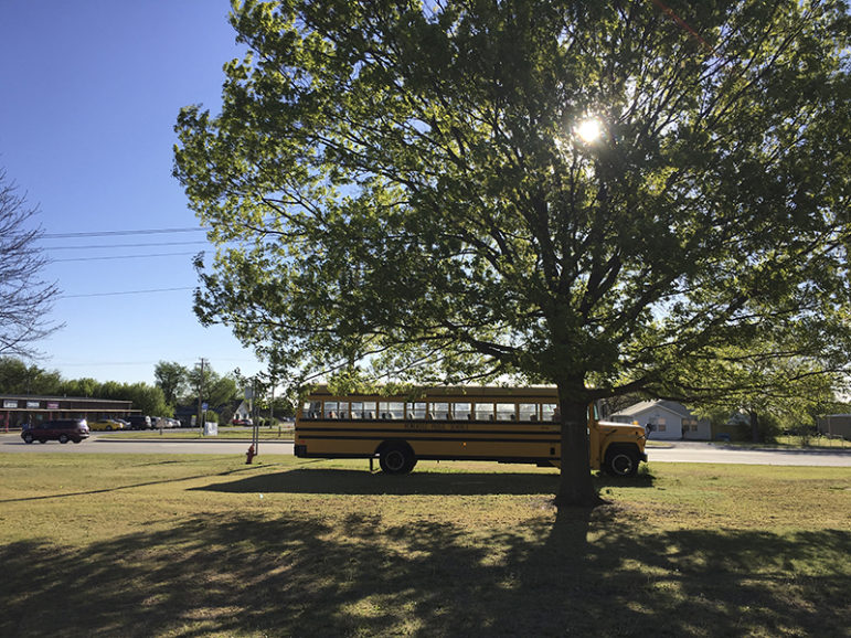 A Newcastle Public Schools bus is seen parked in Newcastle, Okla., on April 6, 2016.  The Newcastle schools are planning to reduce the school week to four days next year as a result of a nearly $1 million budget cut. Photo courtesy of REUTERS/Luc Cohen. *Editors: This photo may only be republished with RNS-OKLAHOMA-ABORTION, originally transmitted on May 27, 2016.