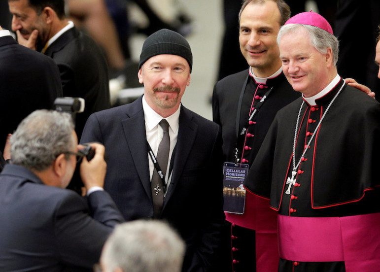 U2 guitarist David Evans, also known by his stage name The Edge, poses with Irish bishop Paul Tighe before listening to U.S. Vice President Joe Biden at the Vatican on April 29, 2016. Photo via REUTERS/Max Rossi. 
