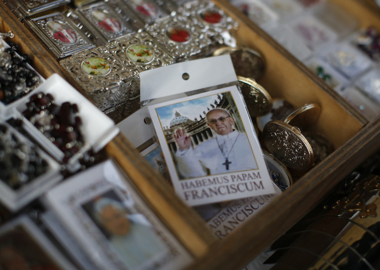 A rosary package with the image of Pope Francis is displayed in a tourist shop outside the Vatican in Rome. Photo courtesy   REUTERS/Paul Hanna 