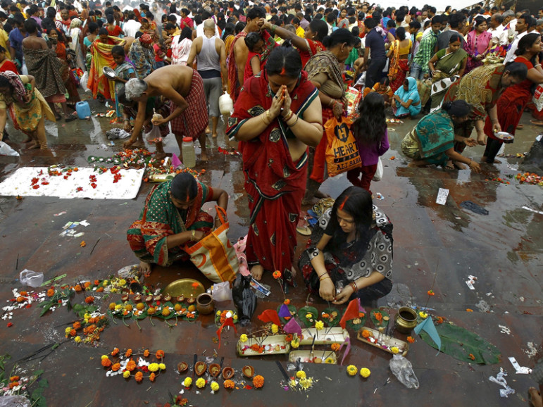 Hindu women worship after taking a holy dip in the Ganges River on the occasion of Guru Purnima in Kolkata, India, on Nov. 25, 2015. Photo courtesy of REUTERS/Rupak De Chowdhuri