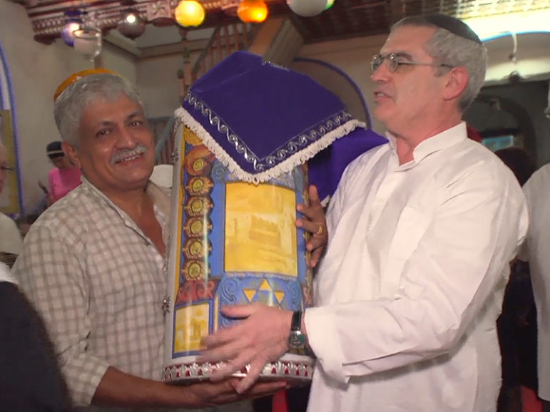 Elias Josephai and Ari Greenspan carry the Torah scroll during a service in the synagogue in Cochin, India. Photo courtesy of Religion & Ethics Newsweekly