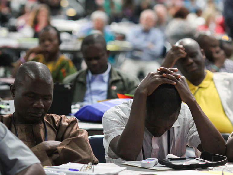 Delegates pray after the statement from Bishop Bruce R. Ough about sexuality and the church from the denomination's Council of Bishops on May 18 at the 2016 United Methodist General Conference in Portland, Ore. Photo by Maile Bradfield, courtesy of UMNS