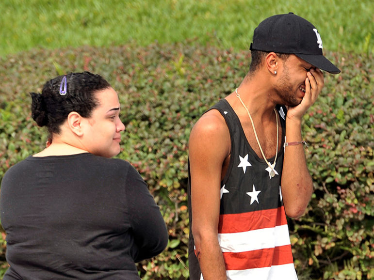 Friends and family members wait outside the Orlando, Fla., police headquarters during the investigation of the deadly shooting at the Pulse nightclub, June 12, 2016. Photo courtesy of REUTERS/Steve Nesius. *Editors: This photo may only be republished with RNS-HATRED-GAYS, originally transmitted on June 13, 2016.