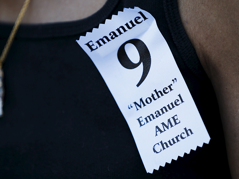 A woman wears an "Emanuel 9" ribbon to the funeral for the Rev. Clementa Pinckney in Charleston, S.C., on June 26, 2015. Photo courtesy of REUTERS/Brian Snyder