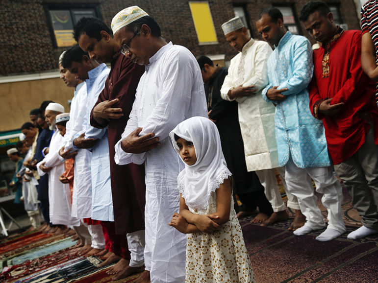 Muslim worshippers pray during Eid al-Fitr services in the Queens borough of New York on July 28, 2014. Photo courtesy of REUTERS/Shannon Stapleton