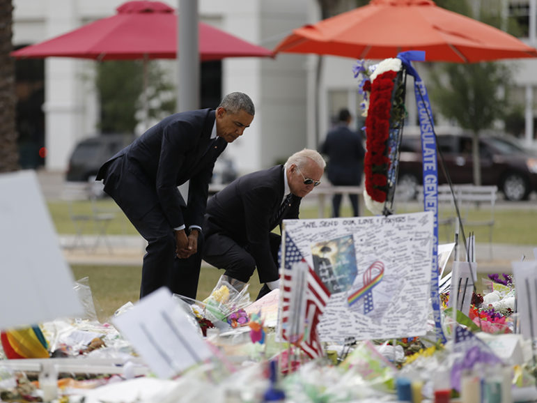 U.S. President Barack Obama and Vice President Joe Biden place flowers at a makeshift memorial for shooting victims of the massacre at a gay nightclub in Orlando, Florida, U.S., June 16, 2016. Photo courtesy of Reuters/Carlos Barria