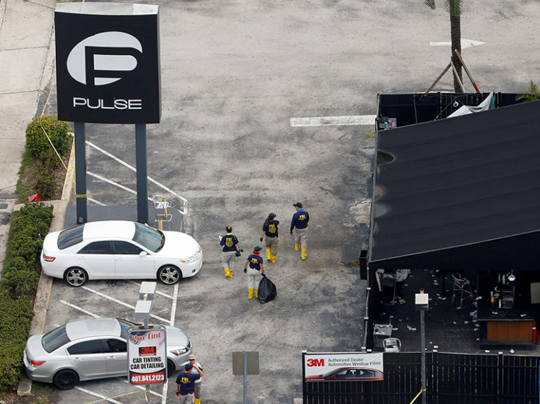 Federal Bureau of Investigation (FBI) officials walk through the parking lot of the Pulse gay night club, the site of a mass shooting days earlier, in Orlando, Florida, on June 15, 2016. Photo courtesy of REUTERS/Adrees Latif
