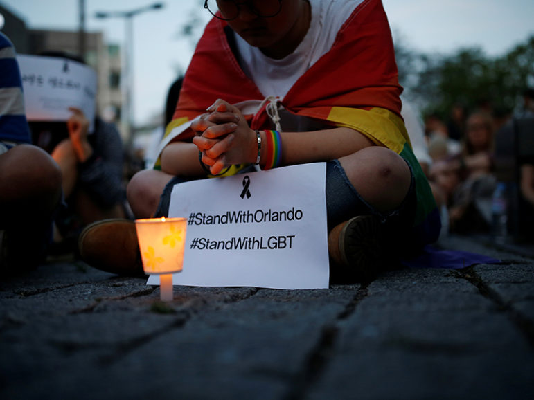 A woman prays during a candlelight vigil in solidarity for the victims of the Orlando, Fla., gay nightclub mass shooting, in Seoul, South Korea, on June 13, 2016. Photo courtesy of REUTERS/Kim Hong-Ji
*Editors: This photo may only be republished with RNS-PINSKY-OPED, originally transmitted on June 13, 2016.
