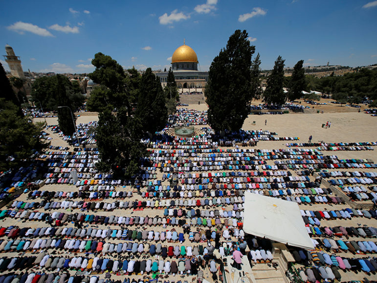 The Dome of the Rock is seen in the background as Palestinians pray on the first Friday of the holy fasting month of Ramadan on the compound known to Muslims as Noble Sanctuary and to Jews as Temple Mount in Jerusalem's Old City on June 10, 2016. Photo courtesy of REUTERS/ Ammar Awad 
*Editors: This photo may only be republished with RNS-RAMADAN-ISRAEL, originally transmitted on June 24, 2016.