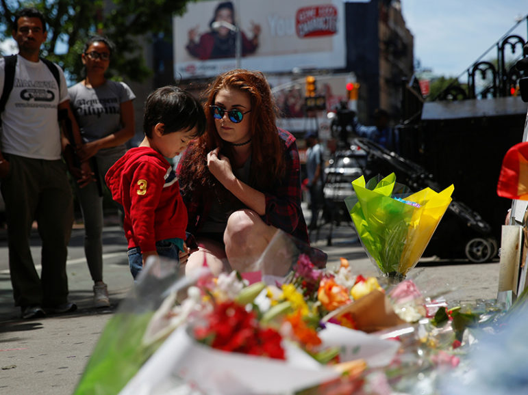 Shelby Heye, a nanny for Nico, 2, speaks with him at a memorial outside The Stonewall Inn remembering the victims of the Orlando massacre in New York, on June 13, 2016. Photo courtesy of REUTERS/Shannon Stapleton
*Editors: This photo may only be republished with RNS-SOCOLOVSKY-OPED, originally transmitted on June 13, 2016.