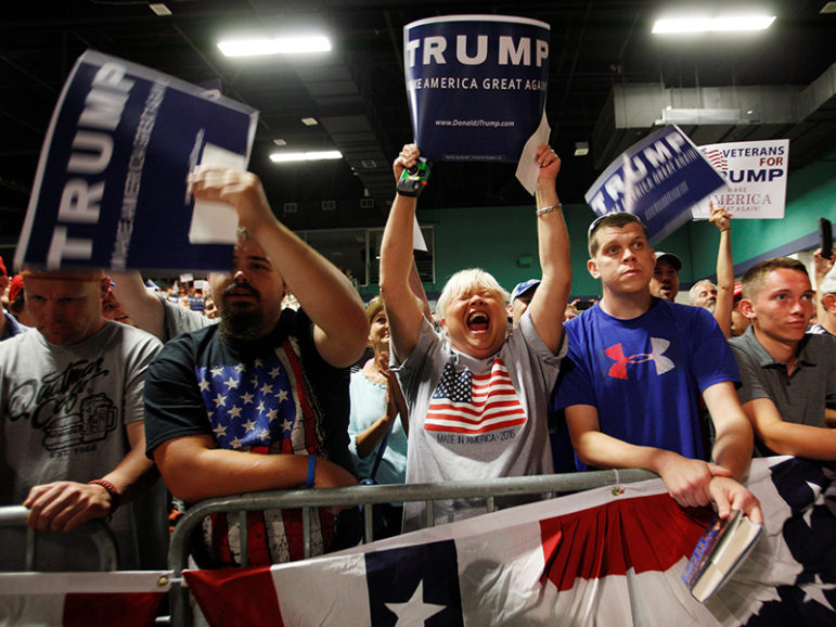 Supporters of Republican presidential candidate Donald Trump react at the start of his campaign rally in Greensboro, North Carolina on June 14, 2016. Photo courtesy of REUTERS/Jonathan Drake