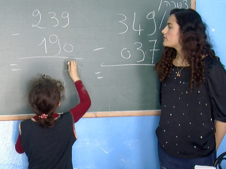 Math teacher Anael Haddad teaches a second-grade class for girls at a Jewish school in Hara Kbira. Haddad dreams of becoming a lawyer, but she knows that option is closed to her. RNS photo by Elizabeth Bryant