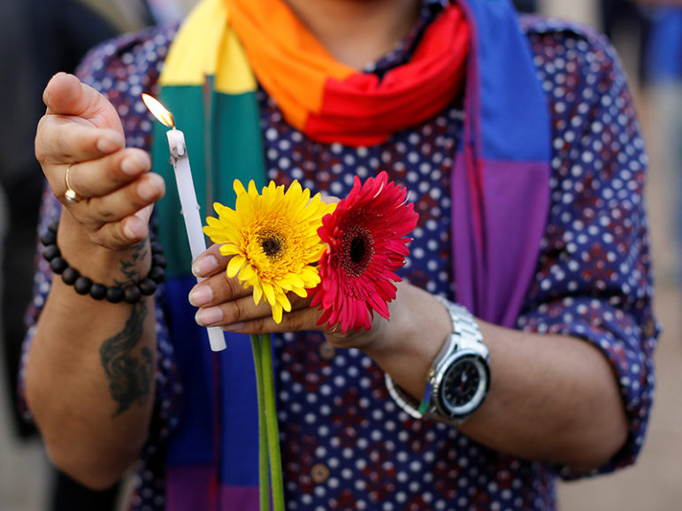 A participant holds a candle June 16, 2016, during a vigil in Mumbai, India, in memory of the victims of the Pulse gay nightclub shooting in Orlando, Fla. Photo courtesy of REUTERS/Danish Siddiqui