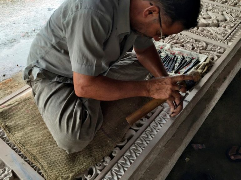 A worker engraves a stone that Hindu nationalist group Vishva Hindu Parishad (VHP) say will be used to build a Ram temple at the disputed religious site in Ayodhya in the northern state of Uttar Pradesh, India, June 16, 2016. Photo via Reuters