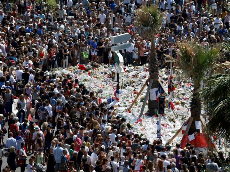 A view shows the crowd gathering near a makeshift memorial on the Promenade des Anglais during a minute of silence on July 18, 2016, the third day of national mourning to pay tribute to victims of the truck attack along the Promenade des Anglais on Bastille Day that killed scores and injured as many in Nice, France. Photo by Eric Gaillard/REUTERS