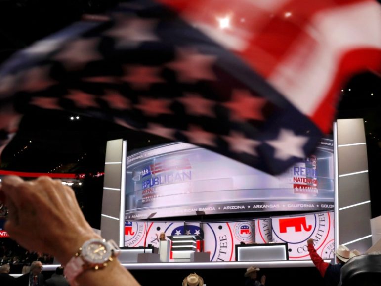 A delegate waves a United States flag in front of the stage July 18, 2016, at the Republican National Convention in Cleveland, Ohio. Photo by Brian Snyder/REUTERS