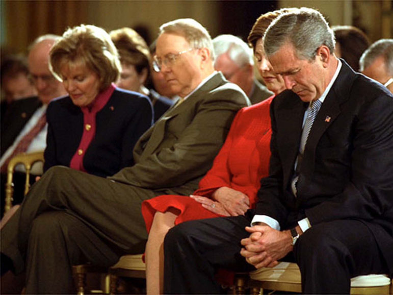 (RNS1-JUL14) National Day of Prayer Chairwoman Shirley Dobson and her husband, religious broadcaster and political activist James Dobson, bow their heads with President Bush and wife Laura during a May ceremony in the East Room of the White House. SEE ``CHRISTIAN-RIGHT,'' transmitted July 14. (White House photo)