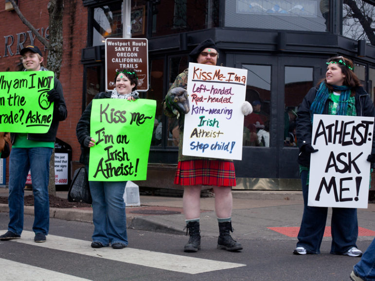 (RNS1-mar17) The Kansas City Atheist Coalition held signs, fielded questions and handed out science-related toys to passing children in Kansas City, Mo., on March 17, 2013, during St. Patrick's Day celebrations.  The event, which they called 