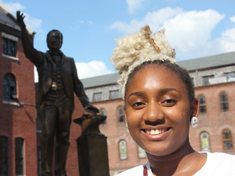 Daja Williams of Nashville, Tenn., visited the bronze statue of Richard Allen, founder of the African Methodist Episcopal Church, on the property of Mother Bethel AME Church in Philadelphia on July 6, 2016. RNS photo by Adelle M. Banks