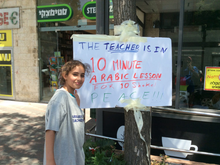 A young girl gives Arabic lessons on the street in West Jerusalem: 10 minutes for 10 shekels, or about $2.50. RNS photo by Rabbi Jeffrey Salkin