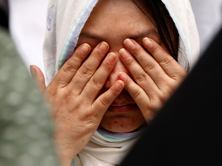 A relative wipes her tears after seeing the coffin of a victim who was killed in the attack on the Holey Artisan Bakery and the O'Kitchen Restaurant, during a memorial ceremony in Dhaka, Bangladesh, on July 4, 2016. Photo courtesy of REUTERS/Adnan Abidi
*Editors: This photo may only be republished with RNS-BANGLADESH-MARTYRS, originally transmitted on July 6, 2016.