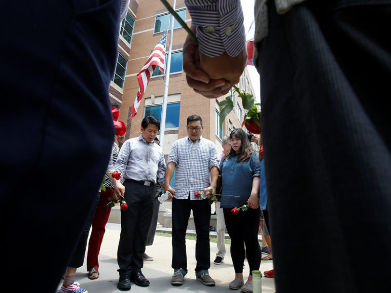 People hold hands as they sing and pray at a makeshift memorial at Dallas police headquarters on July 9, 2016 following the multiple police shootings in Dallas. Photo courtesy of REUTERS/Carlo Allegri
*Editors: This photo may only be republished with RNS-GUSHEE-OPED, originally transmitted on July 11, 2016.
