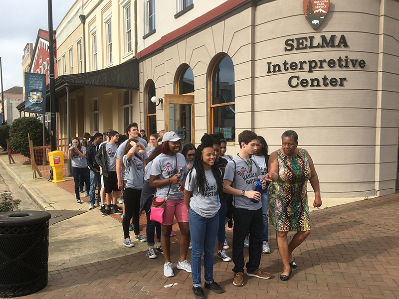Tour guide and civil rights historian Joanne Bland leads students from the University Academy in Kansas City, Missouri and the Hyman Brand Hebrew Academy in Leawood, Kansas just before crossing over the historic Edmund Pettus Bridge in Selma, Alabama. Students were tracing the route of marchers who were beaten on the bridge in 1965 during "Bloody Sunday." Photo courtesy of Beyond Belief