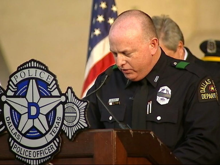 Dallas police Officer Sean Pease prays during a candlelight vigil to honor the five Dallas officers who died in the line of duty. Photo courtesy of NBC5 News, via Officer Sean Pease