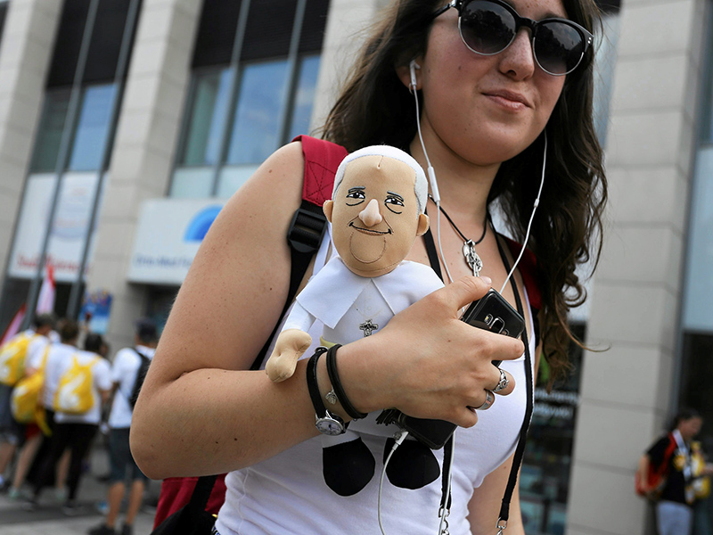 A woman carrying a Pope Francis puppet is seen near Cracovia Stadium in Krakow, Poland on July 27, 2016. Photo courtesy of Agencja Gazeta/Jakub Porzycki/via REUTERS *Editors: This photo may only be republished with RNS-POPE-POLAND, originally transmitted on July 27, 2016.