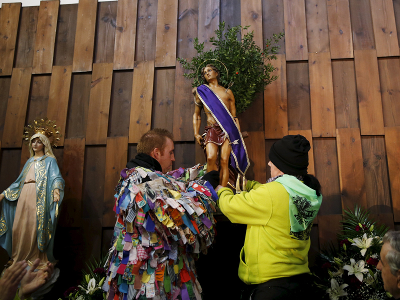 Jarramplas Armando Vicente Vicente, 30, and his sister Laura place a statue of Saint Sebastian at the altar during the Jarramplas traditional festival in Piornal, southwestern Spain, on January 20, 2016. Photo courtesy of REUTERS/Susana Vera