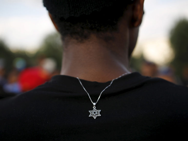 A member of the Ethiopian Jewish community in Israel wears a medallion with the Star of David as he takes part in a ceremony marking the holiday of Sigd in Jerusalem on Nov. 11, 2015. Photo courtesy of REUTERS/ Amir Cohen