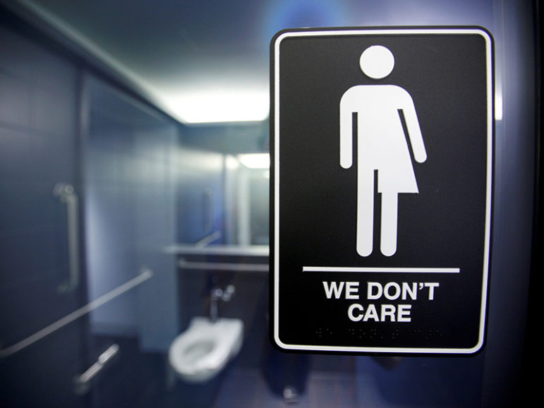 A sign protesting a recent North Carolina law restricting transgender bathroom access is seen in the bathroom stalls at the 21C Museum Hotel in Durham, N.C., on May 3, 2016. Photo courtesy of REUTERS/Jonathan Drake/File photo