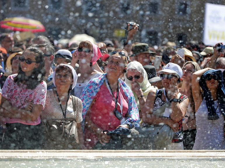 The faithful attend the Angelus player led by Pope Francis in Saint Peter's Square at the Vatican