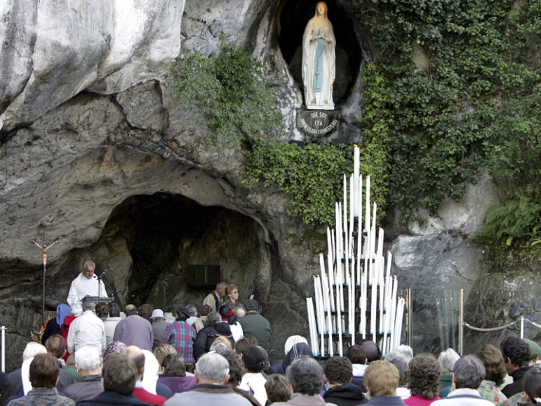 Pilgrims pray in front of Lourdes grotto during the plenary congress of France's bishops in Lourdes, southwestern France. The grotto is the site where the Roman Catholic tradition says St. Bernadette saw visions of Mary in 1858. Photo by Regis Duvignau/Reuters