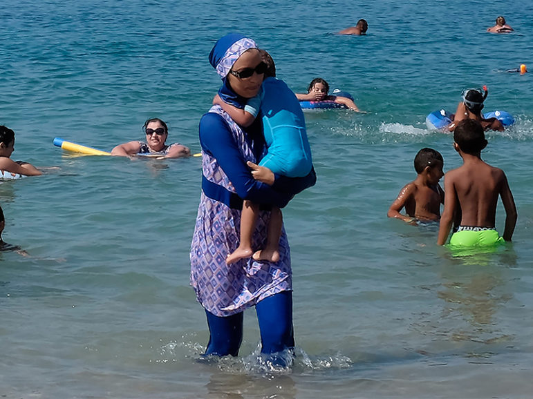 A woman wearing a burkini walks in the water on August 27, 2016 on a beach in Marseille, France, the day after the country's highest administrative court suspended a ban on full-body burkini swimsuits that has outraged Muslims and opened divisions within the government, pending a definitive ruling.  Photo courtesy of REUTERS.
*Editors: This photo may only be republished with RNS-STETZER-OPED, originally transmitted on August 30, 2016.