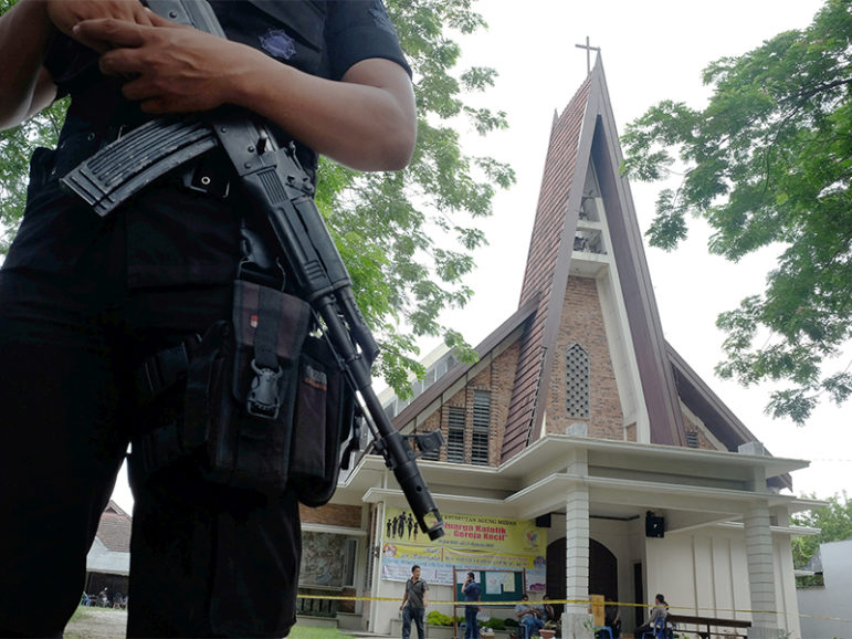 Police are seen outside Saint Joseph's Catholic Church after a suspected terror attack by a knife-wielding assailant on a priest during Sunday service in Medan, North Sumatra, Indonesia, on August 28, 2016. Photo courtesy of Antara Foto/Irsan Mulyadi/ via REUTERS.