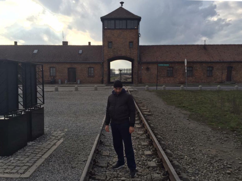 Siavosh Derakhti stands alone during a trip to Auschwitz with his parents. Photo courtesy of Siavosh Derakhti