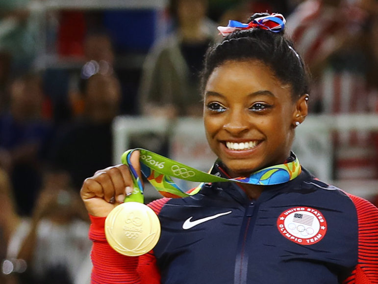 Simone Biles poses with her gold medal after USA won gold the women's team final in Rio de Janeiro on August 9, 2016. Photo courtesy of REUTERS/Mike Blake 
*Editors: This photo may only be republished with RNS-OLYMPICS-BILES, originally transmitted on August 10, 2016.