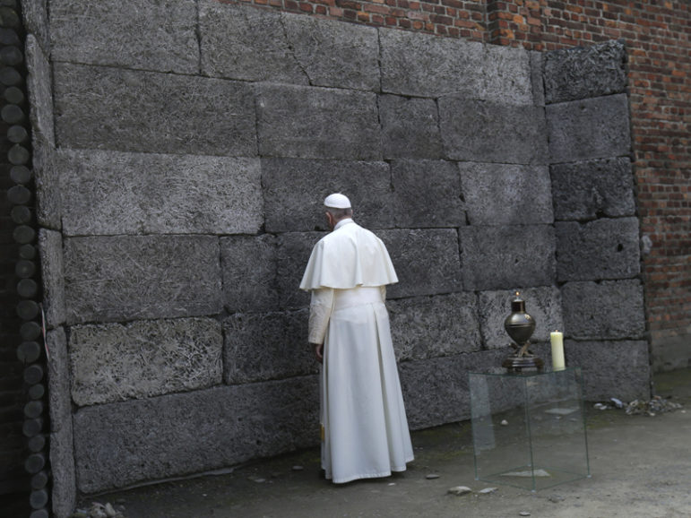 Pope Francis pays respects by the death wall in the former Nazi German concentration and extermination camp Auschwitz-Birkenau in Oswiecim, Poland, on July 29, 2016. Photo courtesy of REUTERS/David W Cerny
