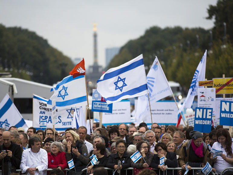 People hold Israeli flags as they listen to speakers during a demonstration against anti-Semitism at Berlin's Brandenburg Gate on Sept. 14, 2014. Photo courtesy of REUTERS/Markus Schreiber/Pool *Editors: This photo may only be republished with RNS-RUDIN-OPED, originally transmitted on Aug. 22, 2016.