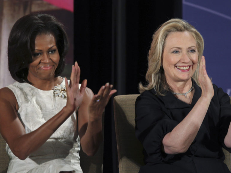 First lady Michelle Obama, left, and then-Secretary of State Hillary Clinton  applaud during the State Department's 2012 International Women of Courage Award winners ceremony in Washington on March 8, 2012. Photo courtesy of REUTERS/Gary Cameron
*Editors: This photo may only be republished with RNS-TREMBATH-OPED, originally transmitted on Aug. 26, 2016.