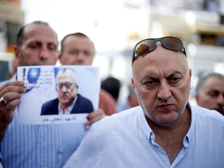 Majed Hattar (R), brother of the Jordanian writer Nahed Hattar, speaks to the media during a sit-in in the town of Al-Fuheis near Amman, Jordan, September 25, 2016. Courtesy of REUTERS/Muhammad Hamed