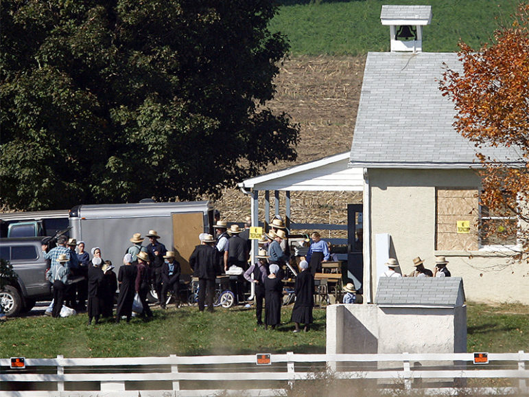 Amish community members work at the scene of the one-room schoolhouse shootings on October 2, 2006, that left five wounded and five dead in Nickel Mines, near Lancaster, PA, on October 9, 2006. The schoolhouse was demolished in 2007. Photo courtesy of REUTERS/Tim Shaffer