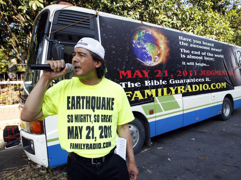 Filipino-American Joel Abalos, 48, and other members of a religious group called Family Radio spread their predictions that the world will end on May 21, 2011, on the streets in Manila May 13, 2011. The U.S. based Christian group took to the streets of Manila earlier this week to preach that the end of the world is fast approaching on May 21 at sunset, to be precise. Photo courtesy of Reuters/Romeo Ranoco 
*Editors: This photo may only be republished with RNS-GUSHEE-OPED, originally transmitted on Sept. 20, 2016.