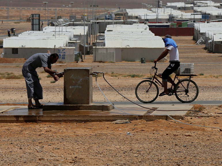 A Syrian refugee washes his face at the Azraq Refugee Camp in Jordan on June 27, 2016. Photo courtesy of Reuters/Muhammad Hamed