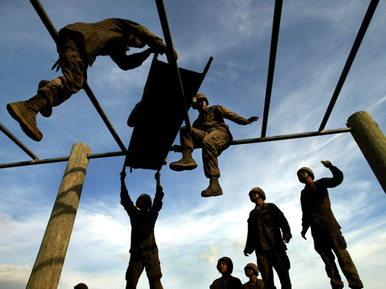 U.S. Marine recruits work through an obstacle course during the 