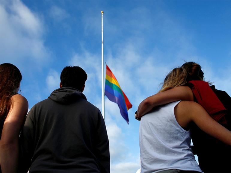Mourners gather under a LGBT pride flag flying at half-staff for a San Diego candlelight vigil in remembrance of mass shooting victims in Orlando, Fla., on June 12, 2016. Photo courtesy of REUTERS/Mike Blake
*Editors: This photo may only be republished with RNS-MARSHALL-OPED, originally transmitted on Sept. 2, 2016.